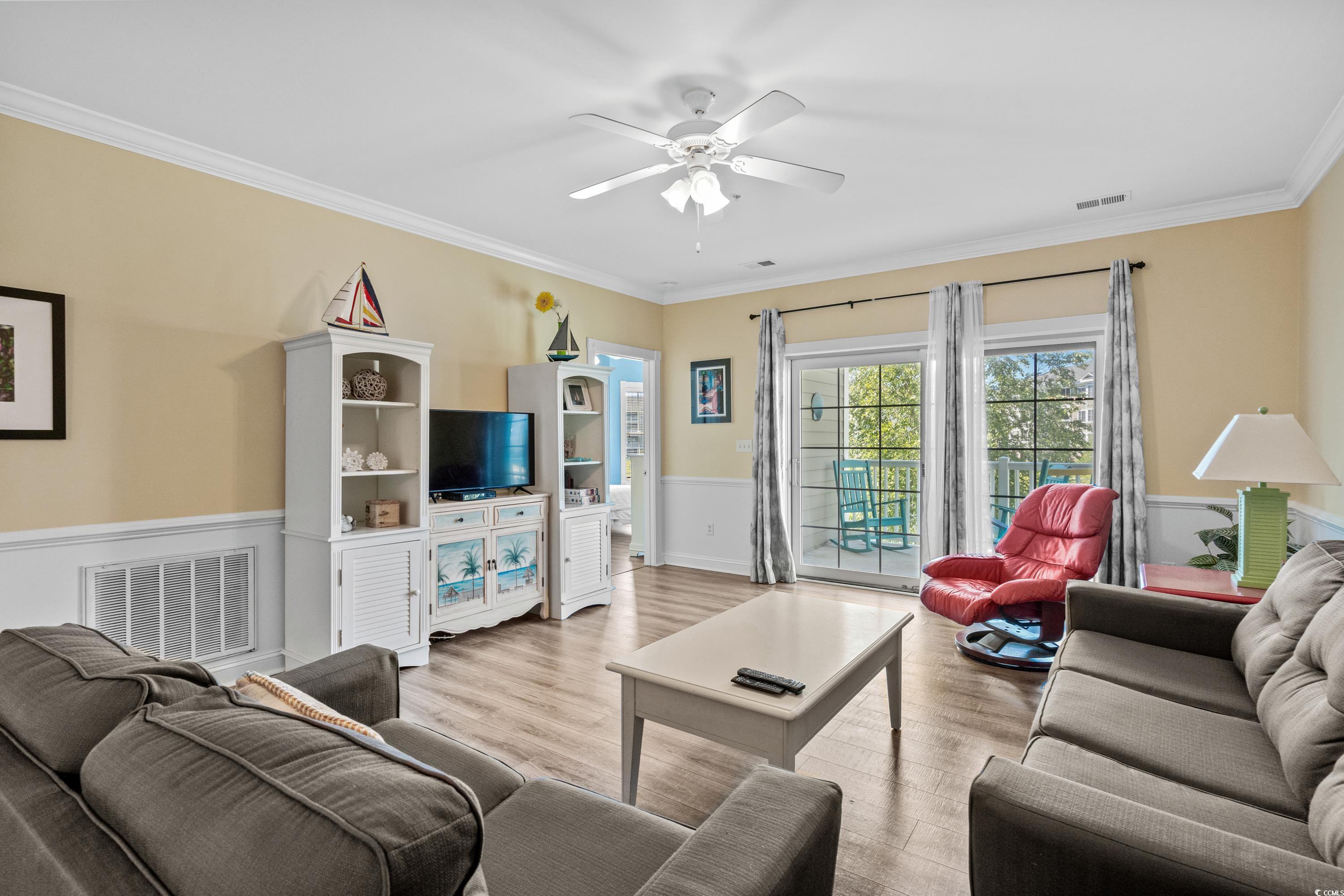 Living room with gray sofas, a red recliner, and sliding doors opening to a balcony.