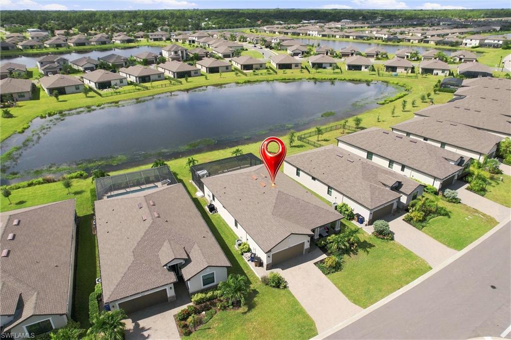 Aerial view of a Fort Myers home beside a pond, marked with a red location pin.