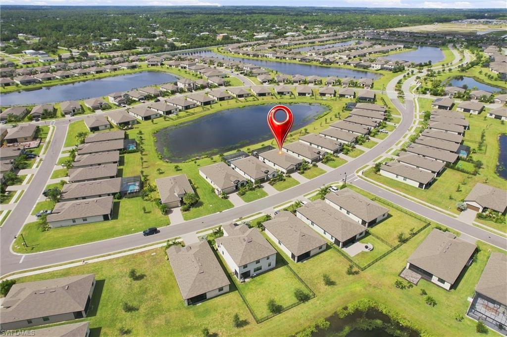 Aerial view of a Fort Myers home beside a neighborhood lake, marked with a red location pin.