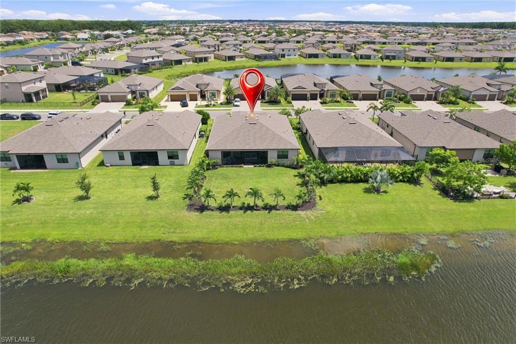 Aerial view of canal-front home marked by a red location pin.