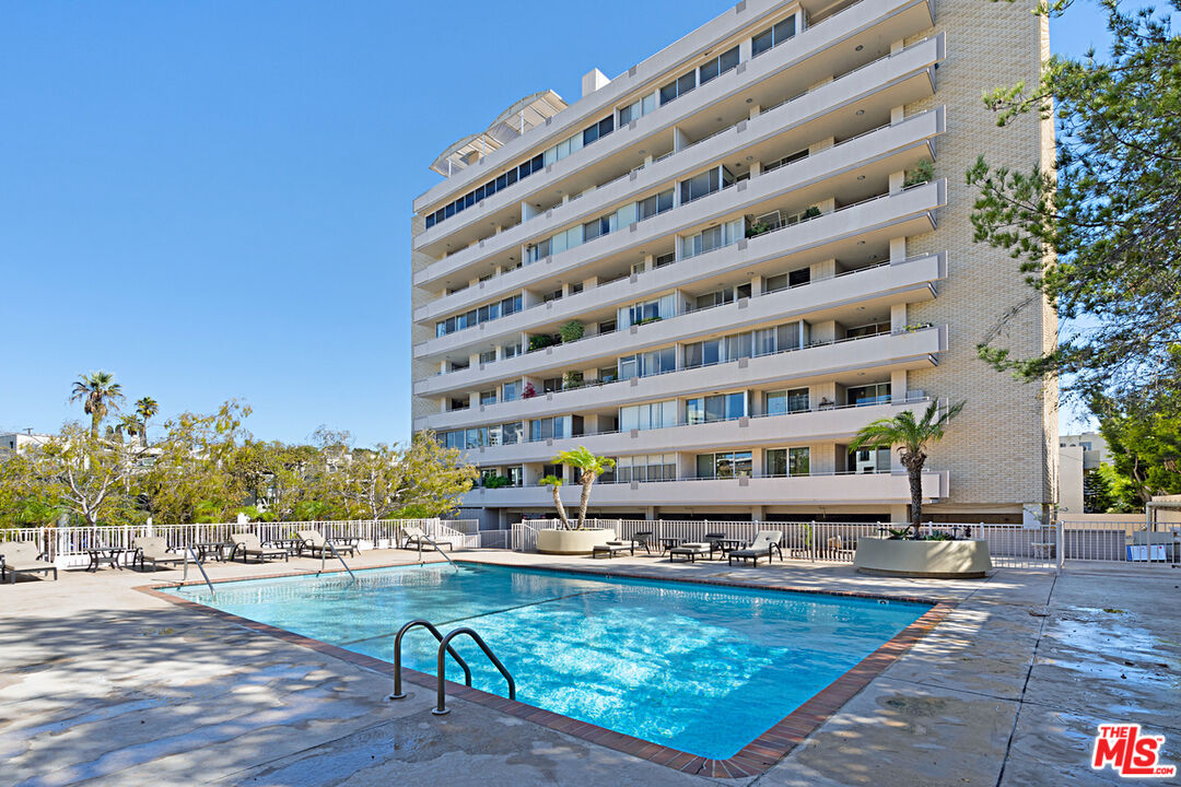 Condominium building at 1333 S Beverly Glen with an outdoor pool and palm trees.