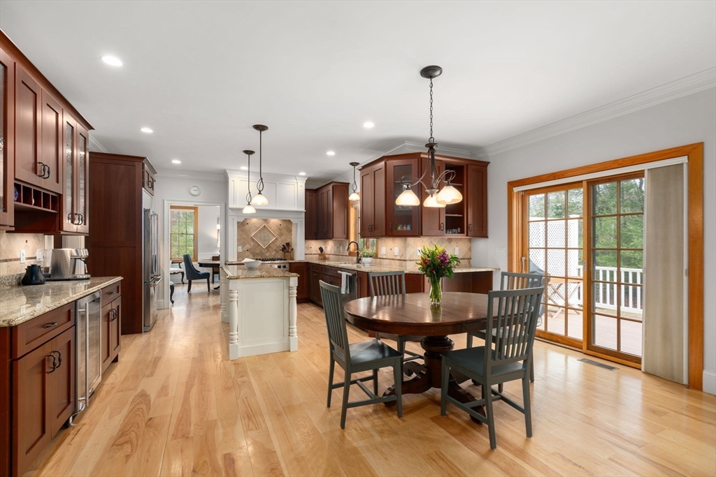 Kitchen and dining area with dark wood cabinets, central island, and sliding doors to a deck.