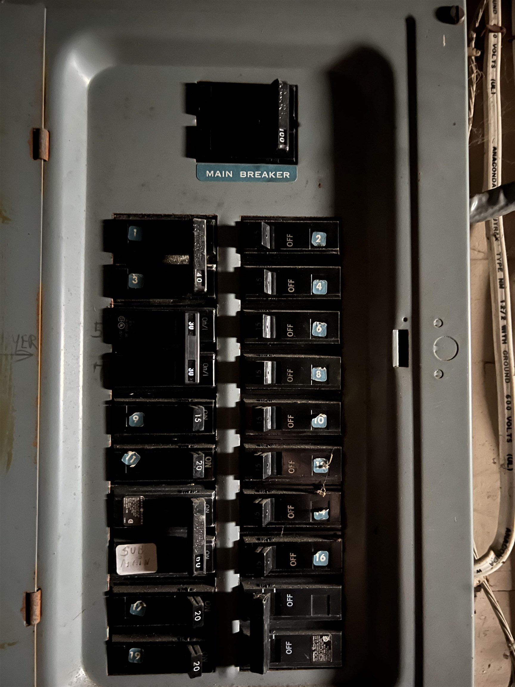 Electrical breaker panel with a labeled main breaker and rows of numbered circuit breakers.
