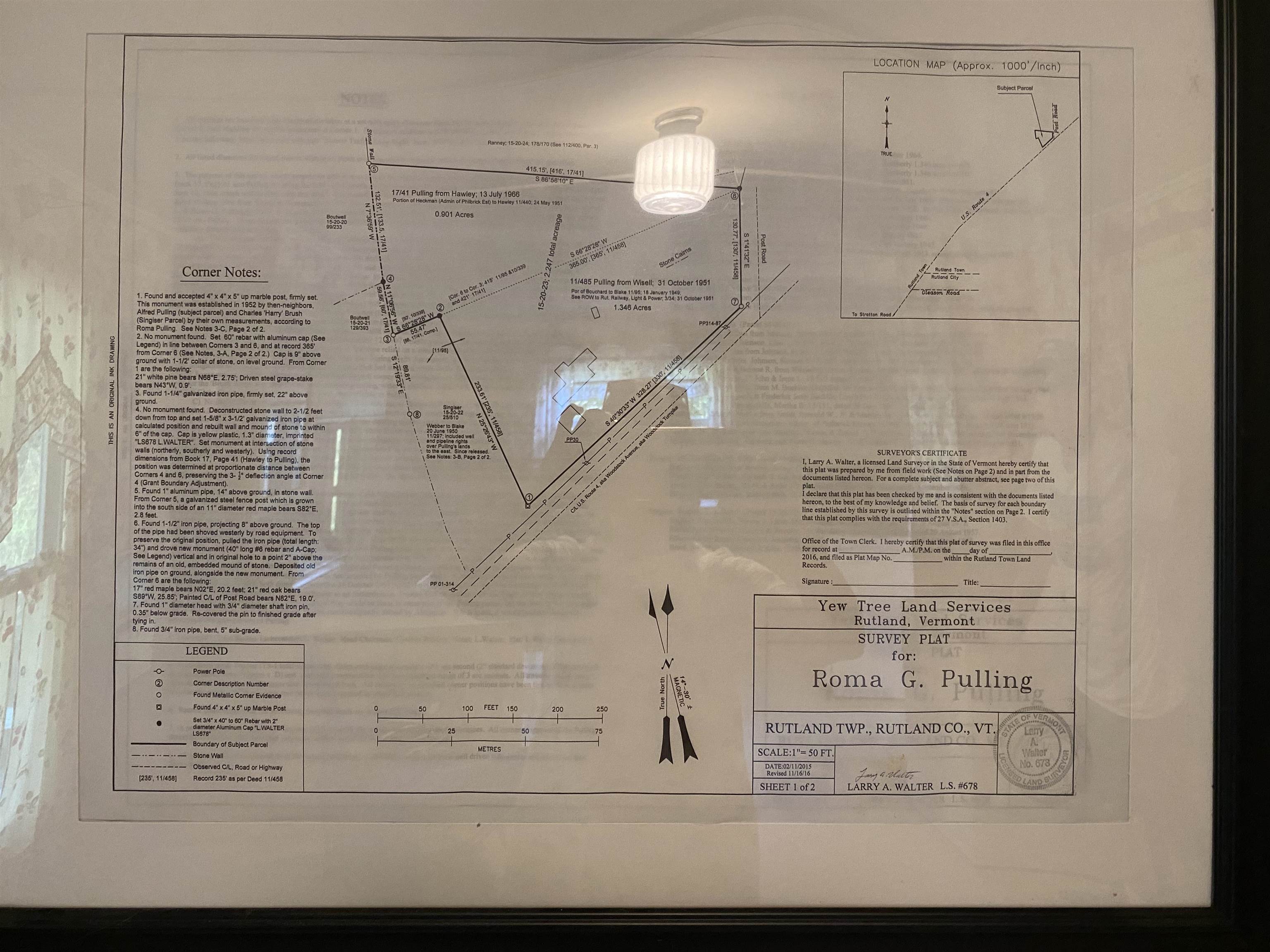 Framed survey plat with marked property boundaries, measurements, and a location map.