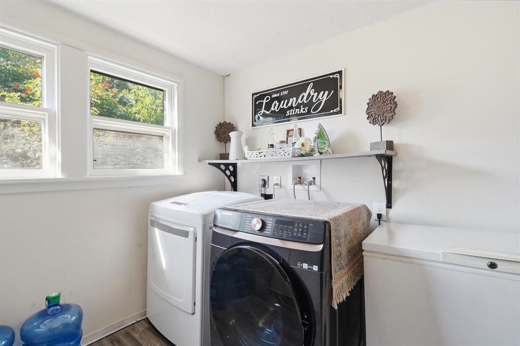 Laundry room with a top-load washer, front-load dryer, and chest freezer beneath a decorative shelf.