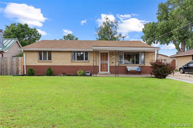 Single-story brick home with a broad green lawn and a small front porch.