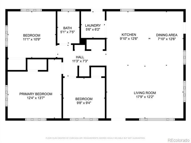 Floor plan showing three bedrooms, a bathroom, laundry room, kitchen, dining area, living room, and hall.
