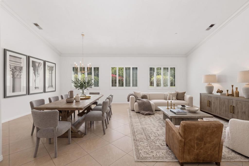 Open-plan living and dining room with a long wood table and cream sofa.