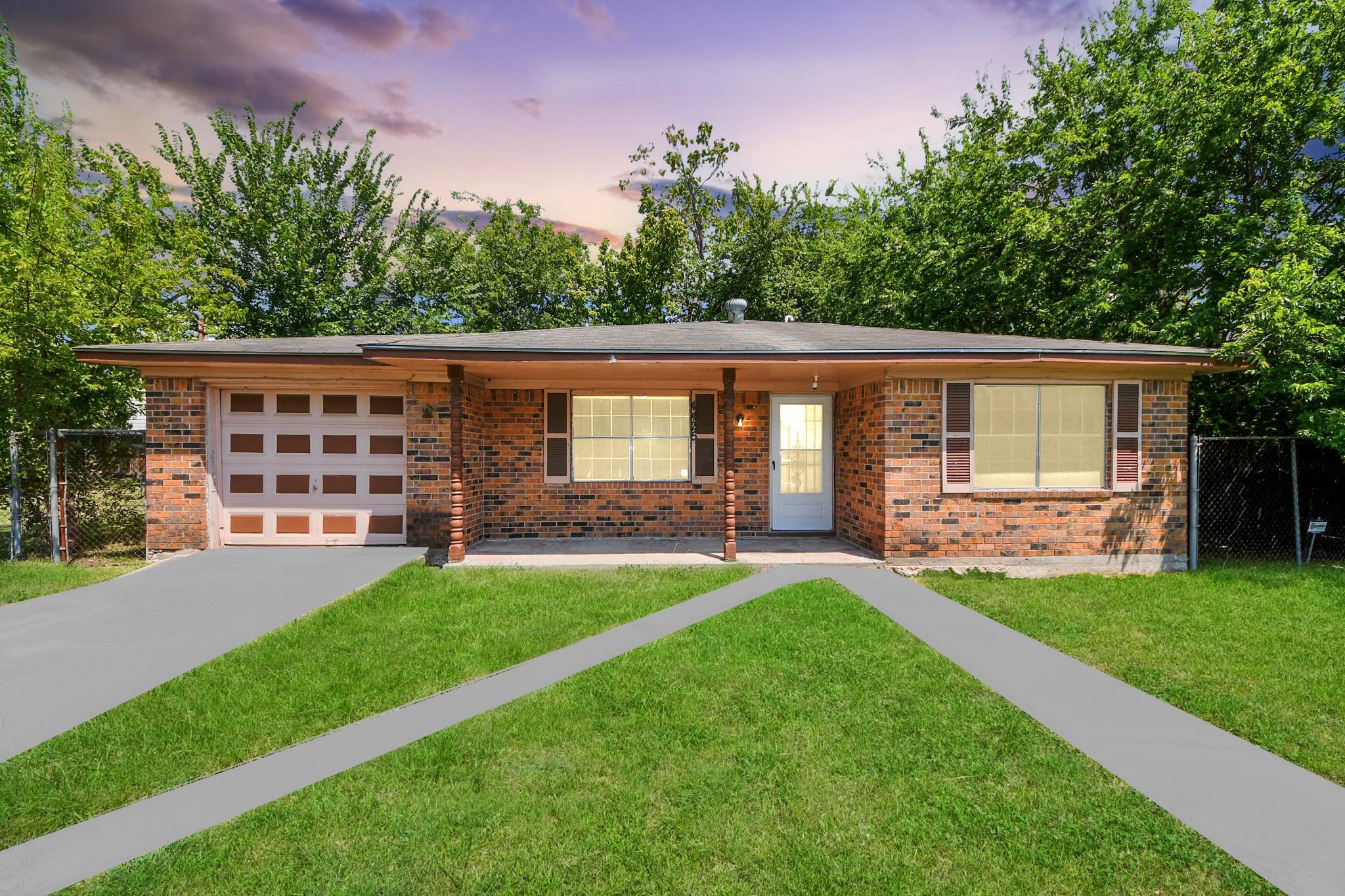Single-story brick house with an attached garage, covered entry, and a green front lawn.