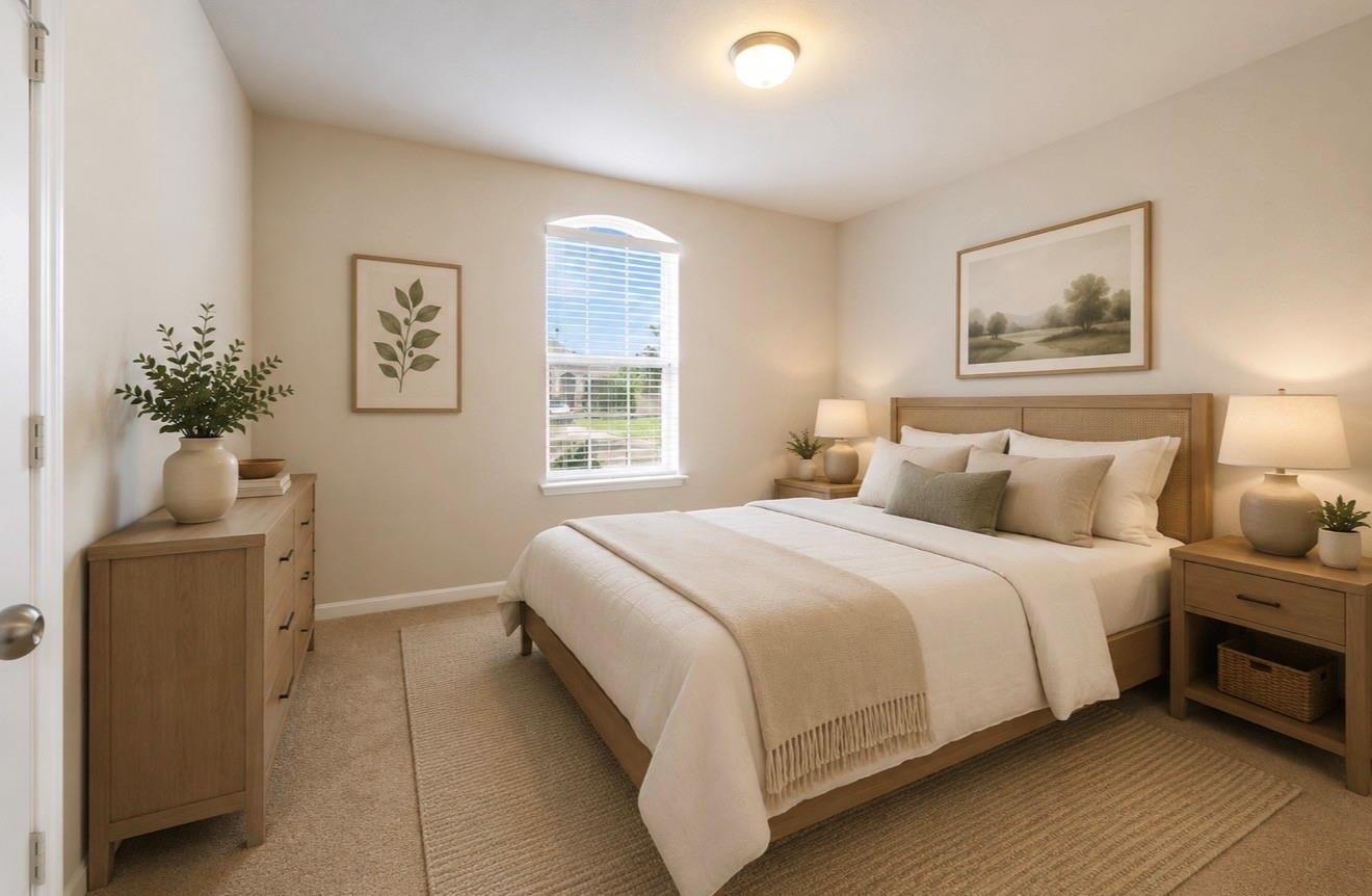 Staged bedroom with a large bed, neutral bedding, and an arched-top window with blinds.