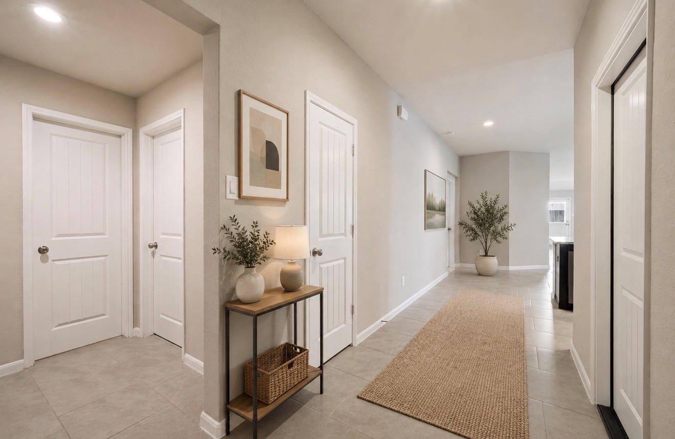 Bright tiled entry hallway with a woven runner and decorated console table.