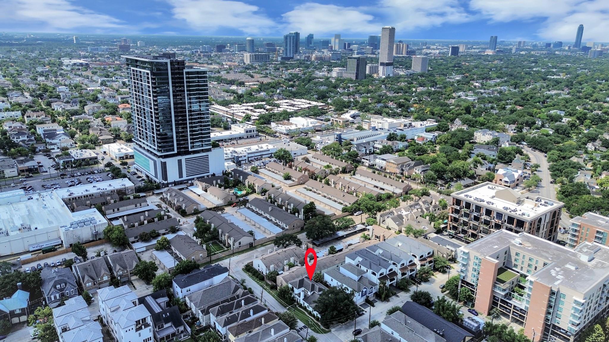 Aerial view of the property, marked among Houston homes with the downtown skyline beyond.