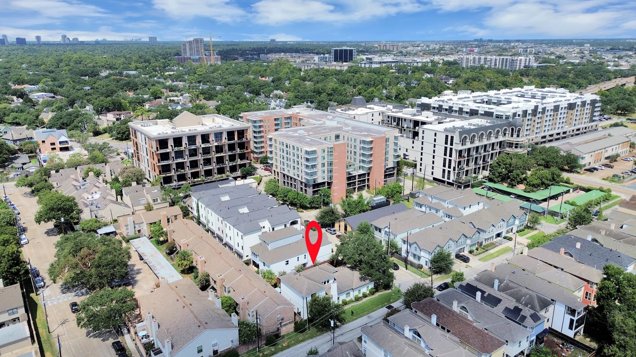 Aerial view of 1202 Gross Street marked in red, amid Houston homes and nearby mid-rise buildings.