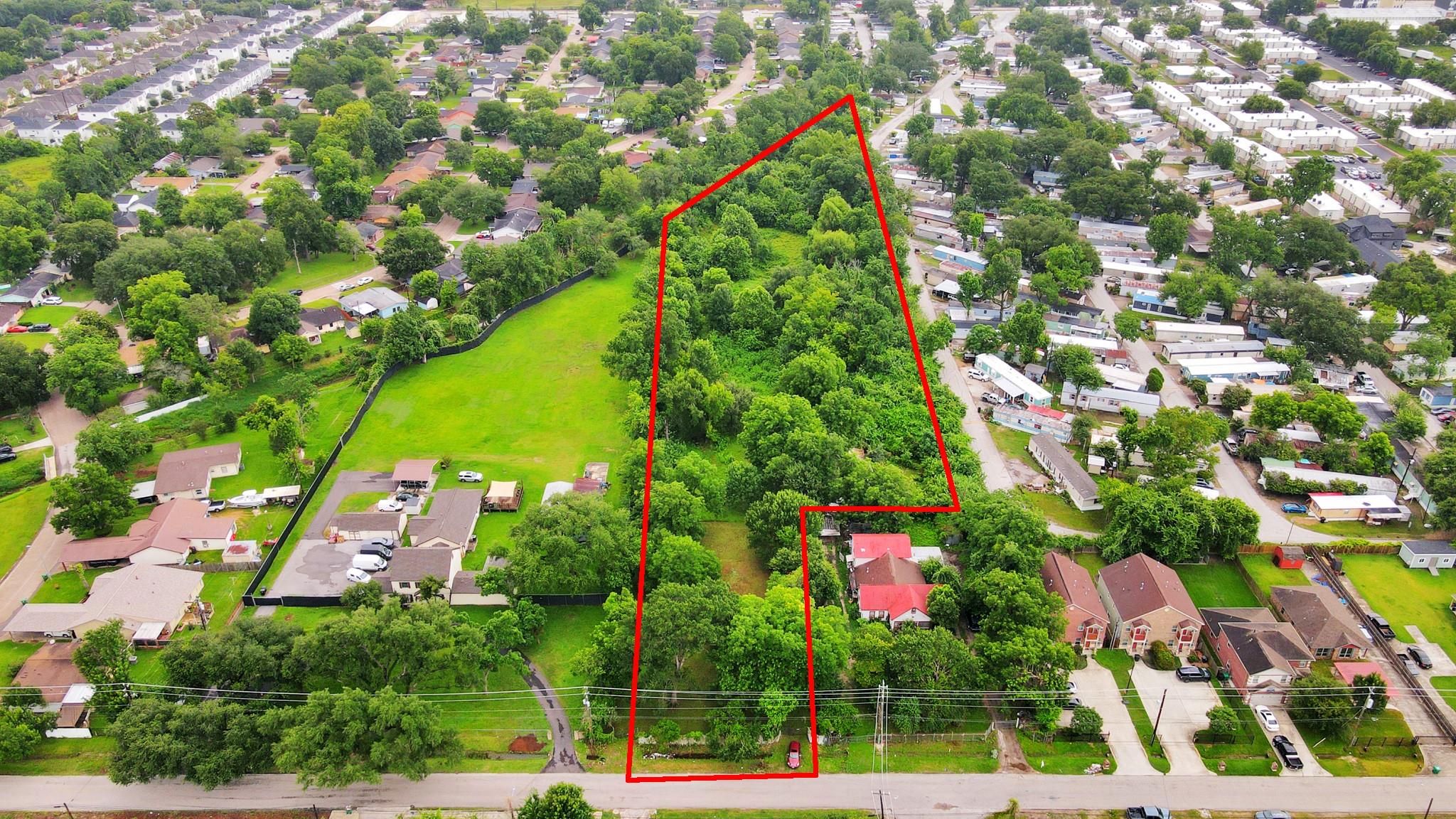 Wooded parcel outlined in red, extending from a road into a residential neighborhood.