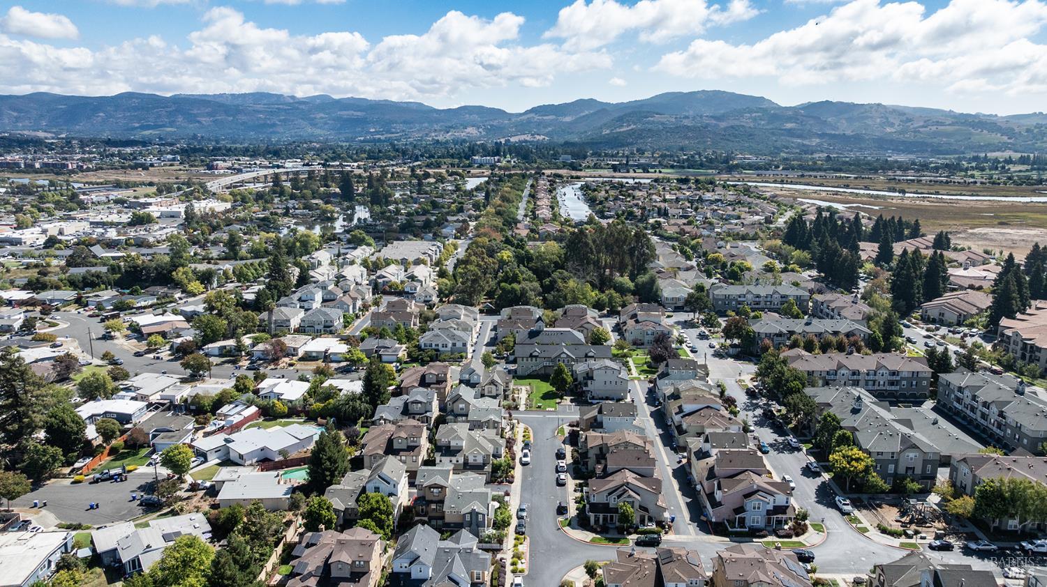 Aerial view of a residential neighborhood with mountains on the horizon.