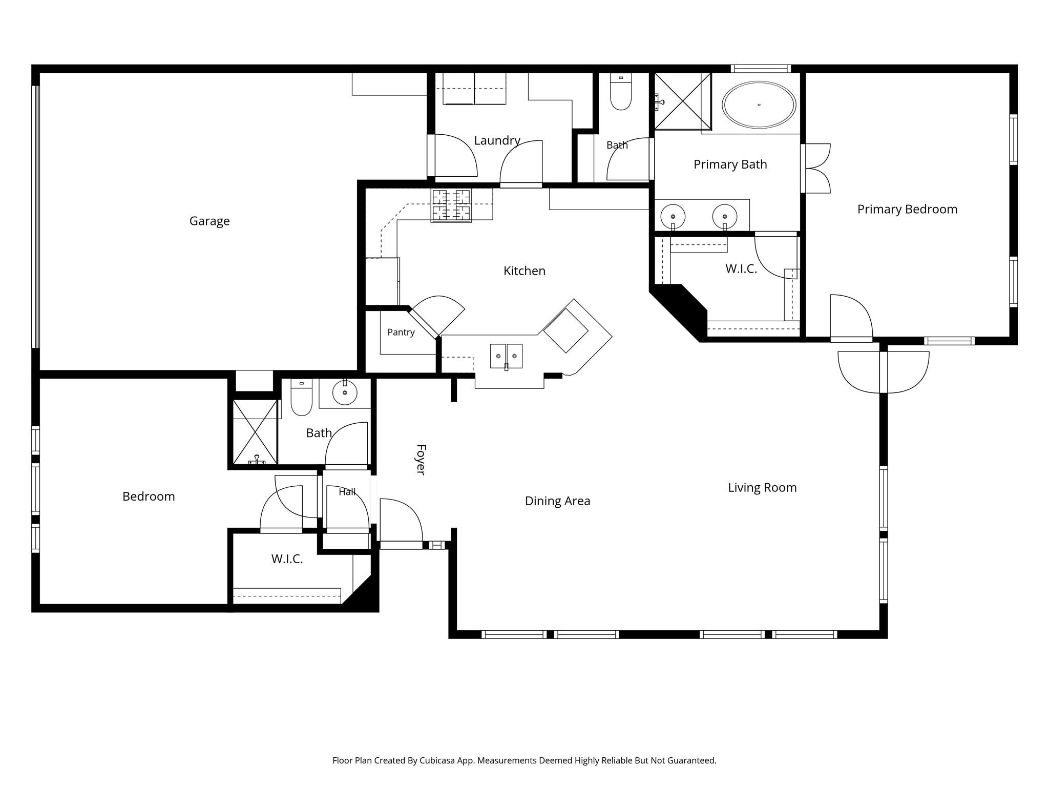 Floor plan showing the garage, kitchen, living and dining rooms, two bedrooms, bathrooms, and walk-in closets.