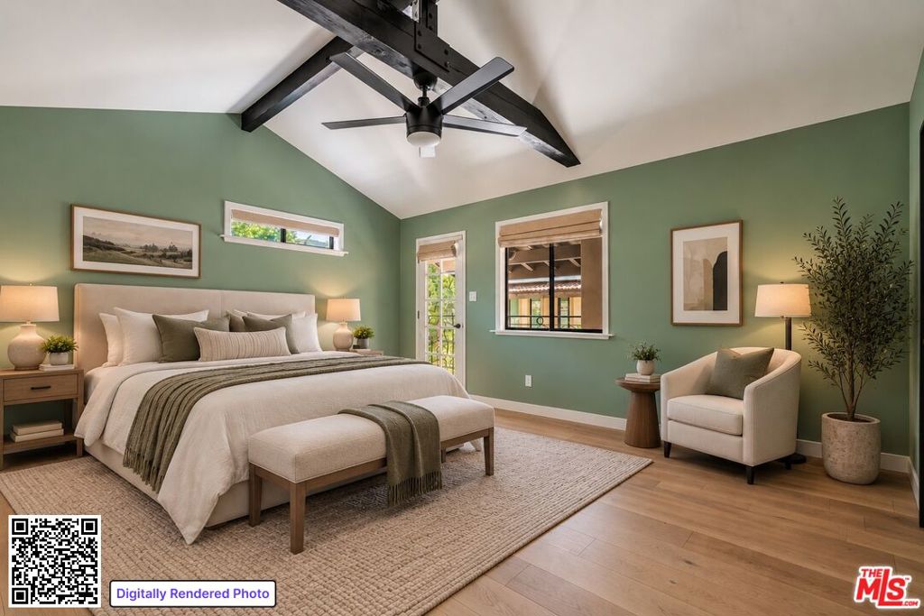 Staged primary bedroom with a vaulted beamed ceiling, green walls, and a king bed.