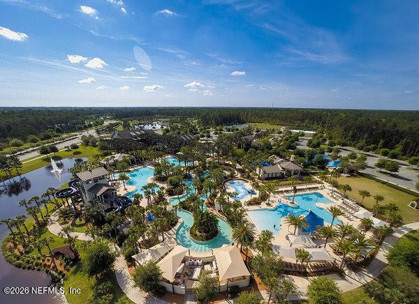 Aerial view of a community pool complex with a lazy river and water slides.
