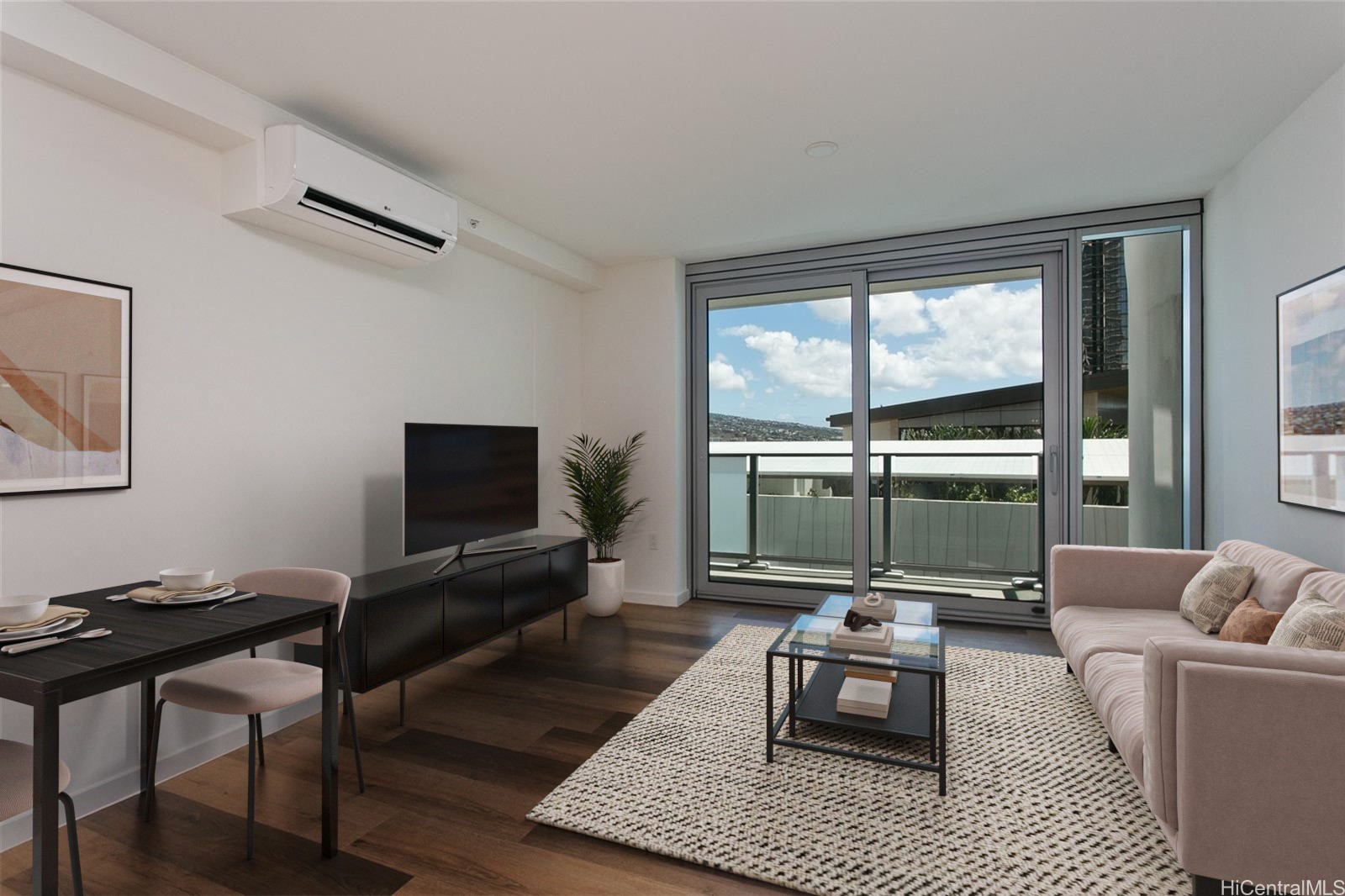 Furnished living room with dark wood floors and sliding glass doors opening to a balcony.