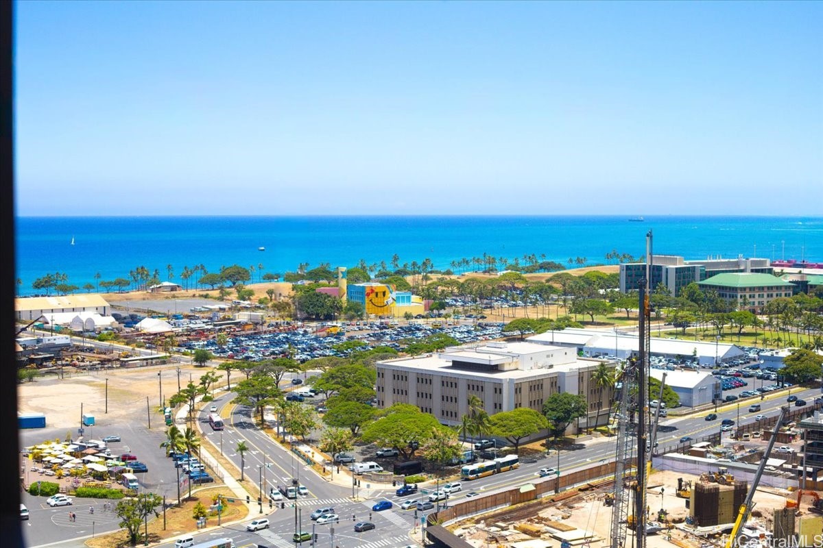 Coastal Honolulu view with the Pacific Ocean, shoreline, and city streets below.