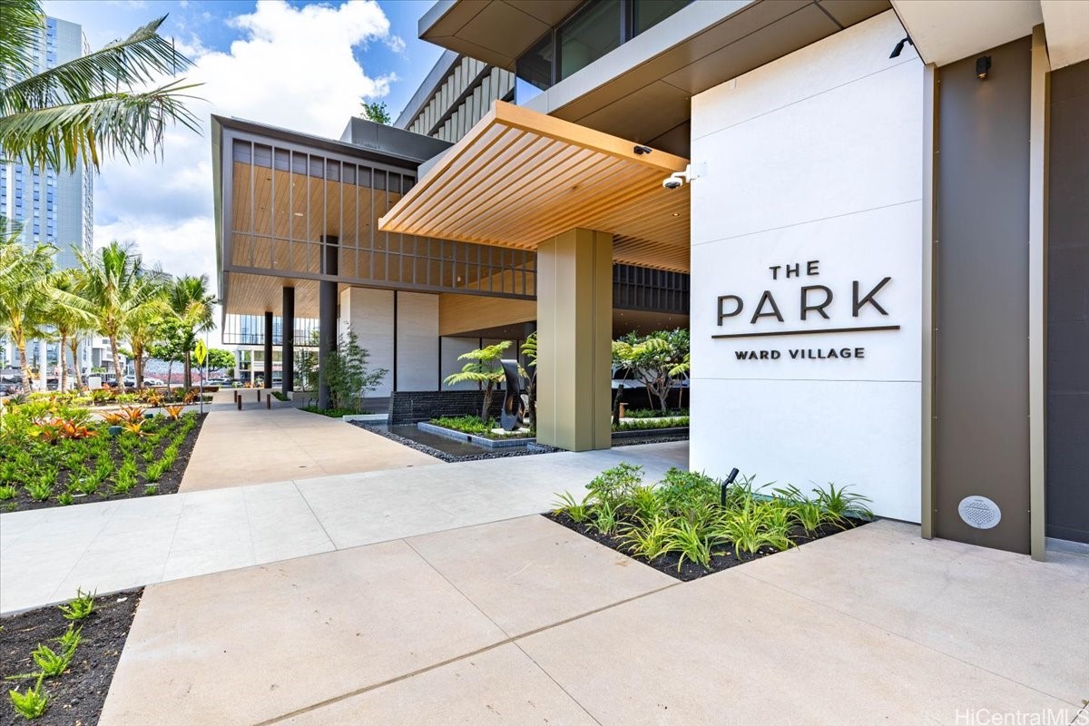 The Park Ward Village entrance with a wood-slat canopy and landscaped walkway.