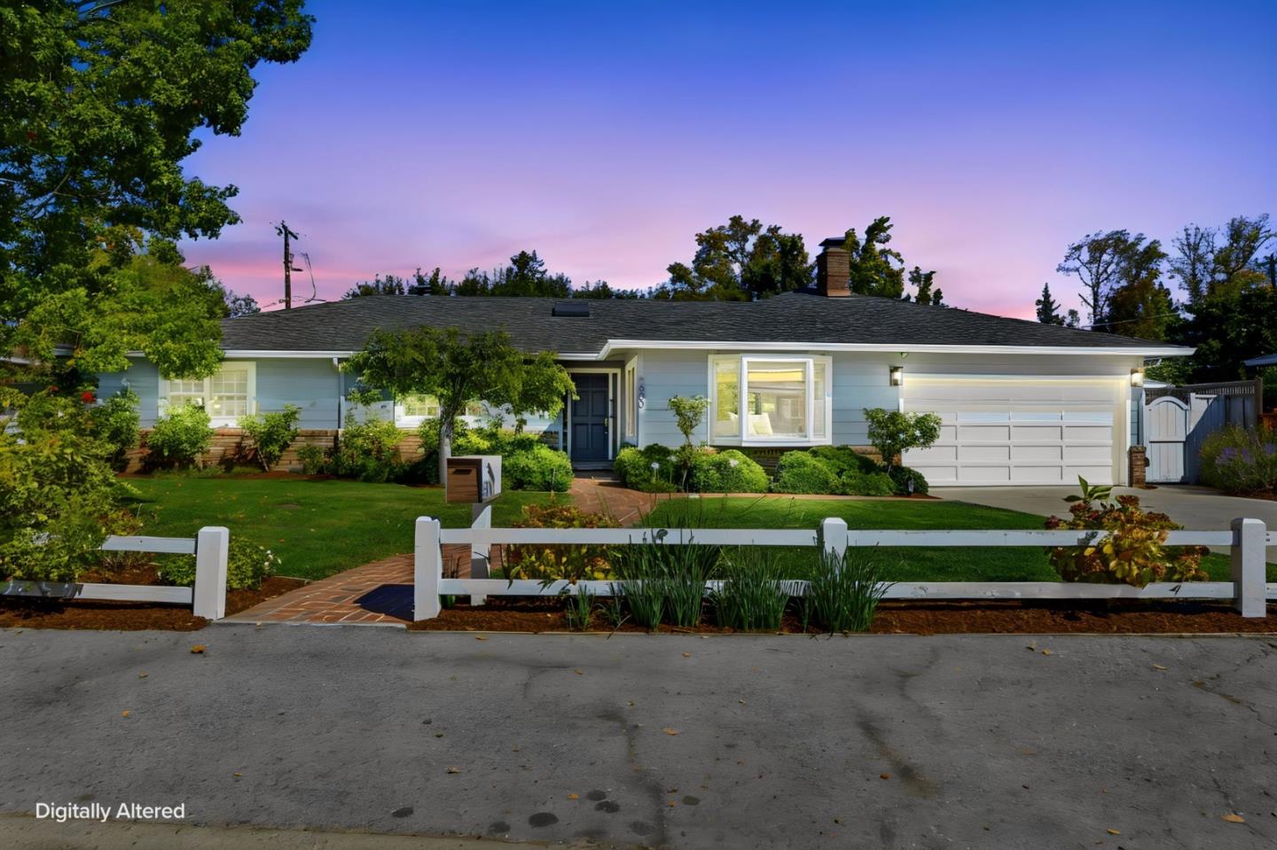 Single-story blue home with a white garage and front fence at dusk.