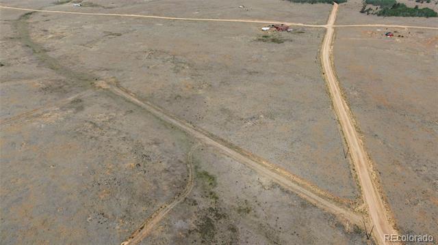 Aerial view of vacant rural land crossed by dirt roads.