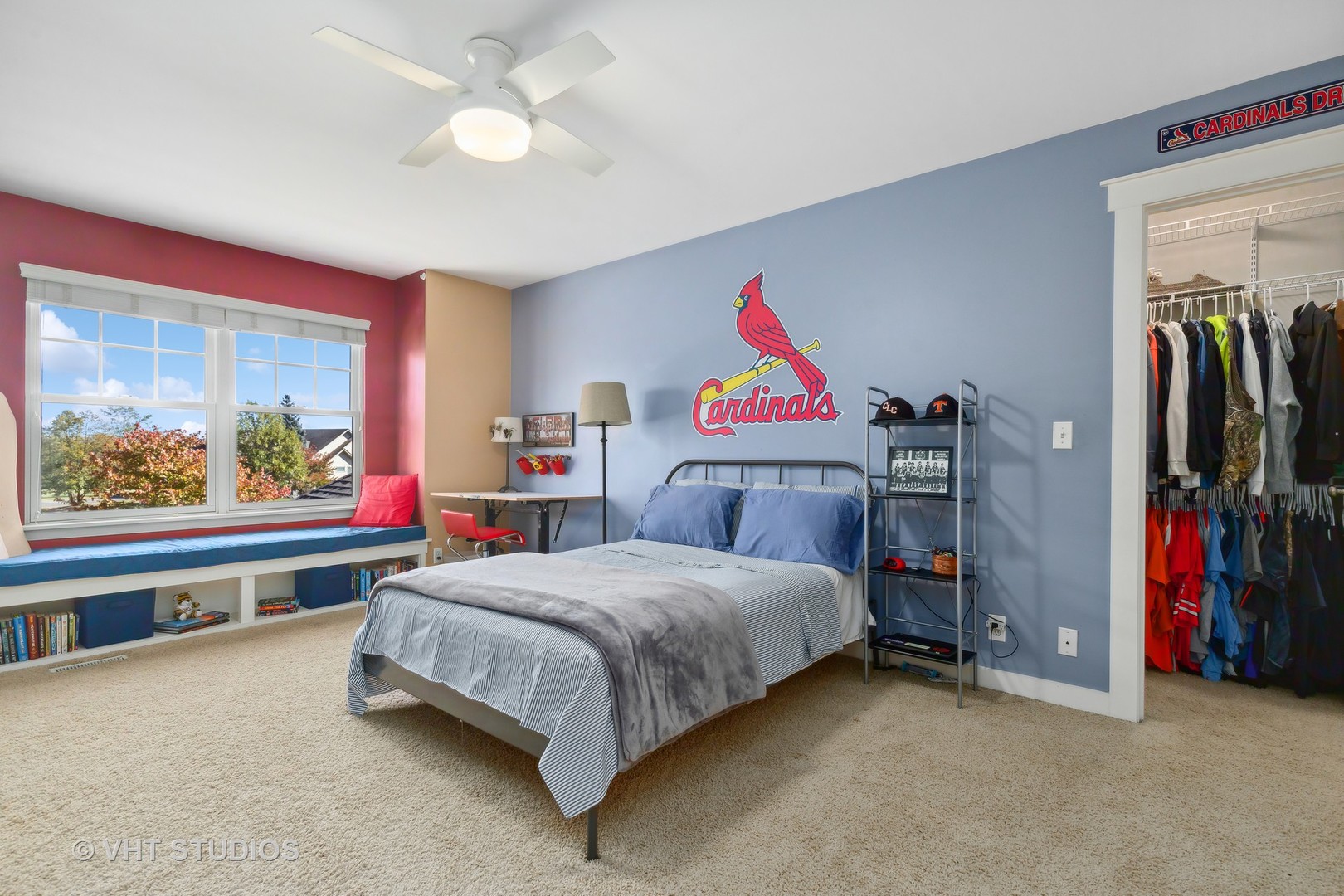 Bedroom with Cardinals wall décor, a window seat, and an open walk-in closet.