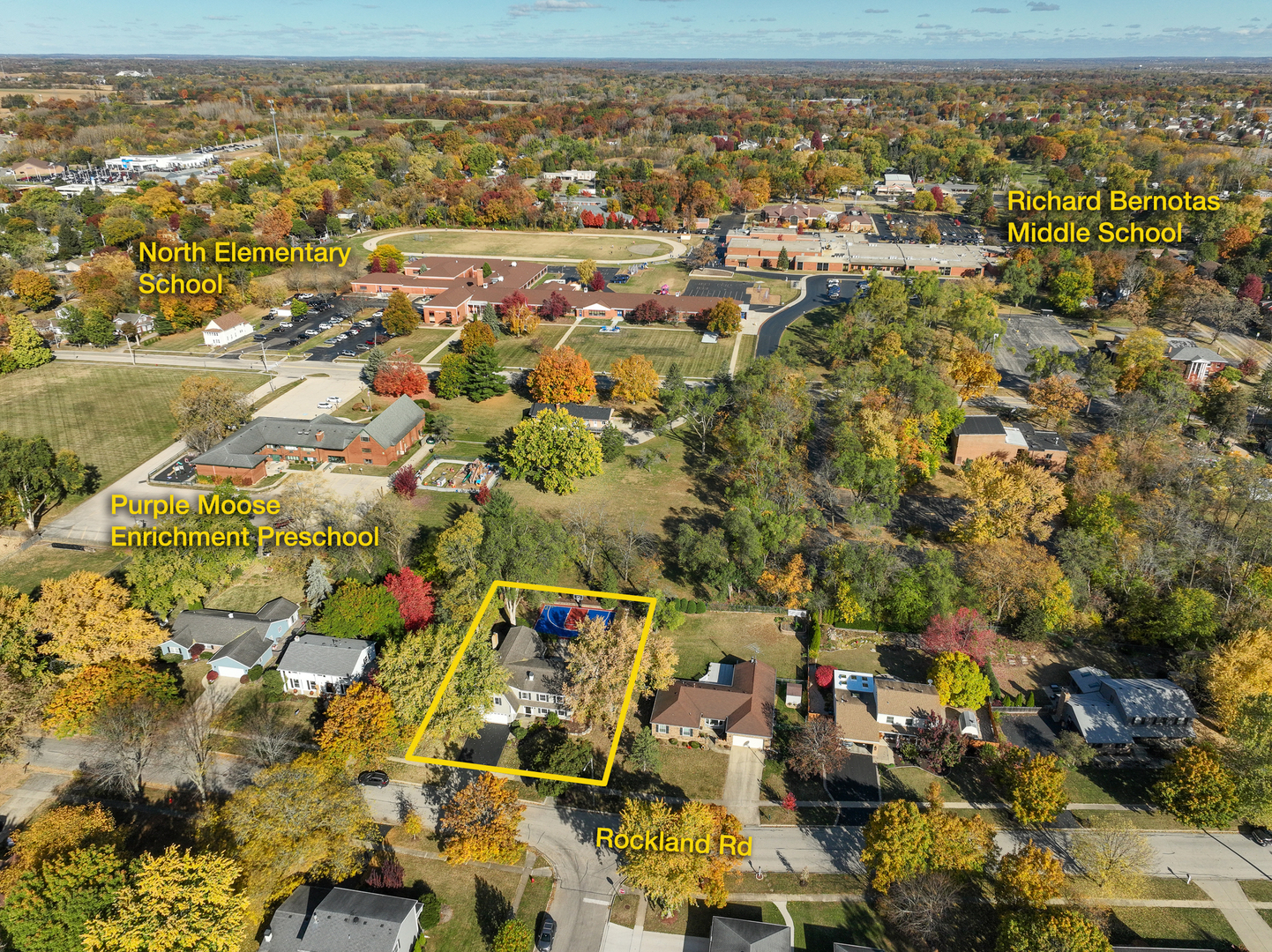 Aerial view of the highlighted home on Rockland Road, with nearby schools and autumn trees.