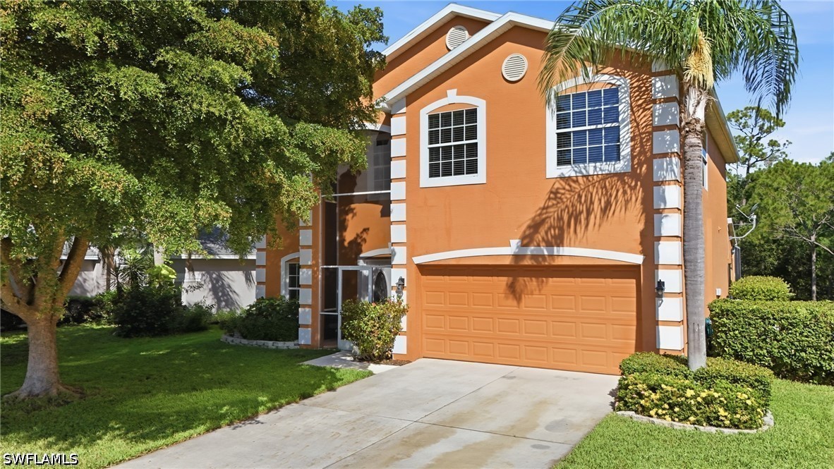 Orange two-story stucco house with white trim, attached garage, palm trees, and driveway.
