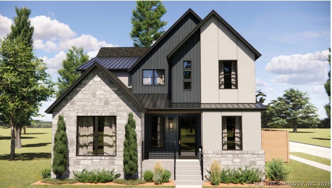 Two-story home with dark siding, pale stone facade, and a covered front entry.
