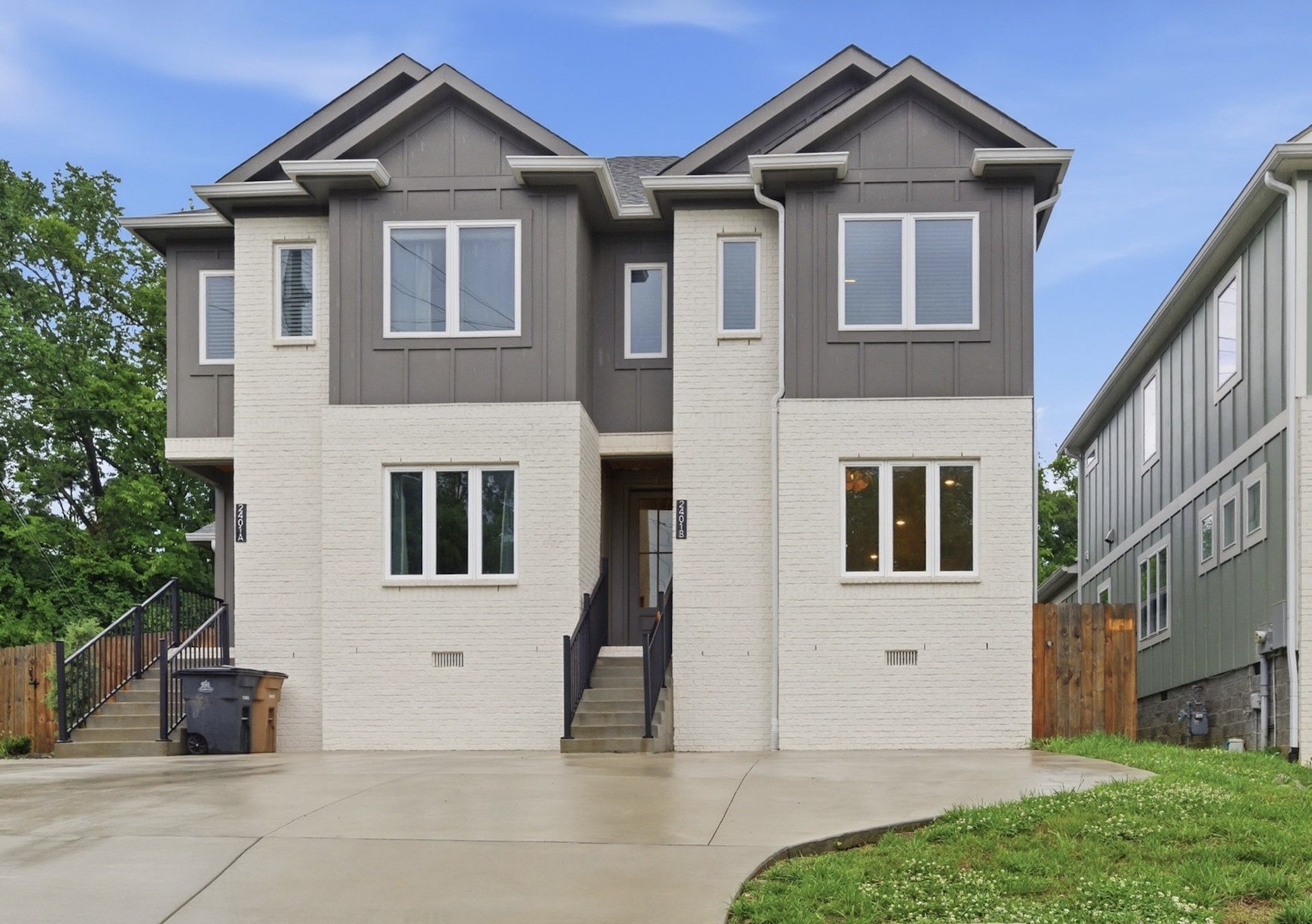 Attached two-story homes at 2401A and 2401B Inga St, with white brick facades and separate front entrances.