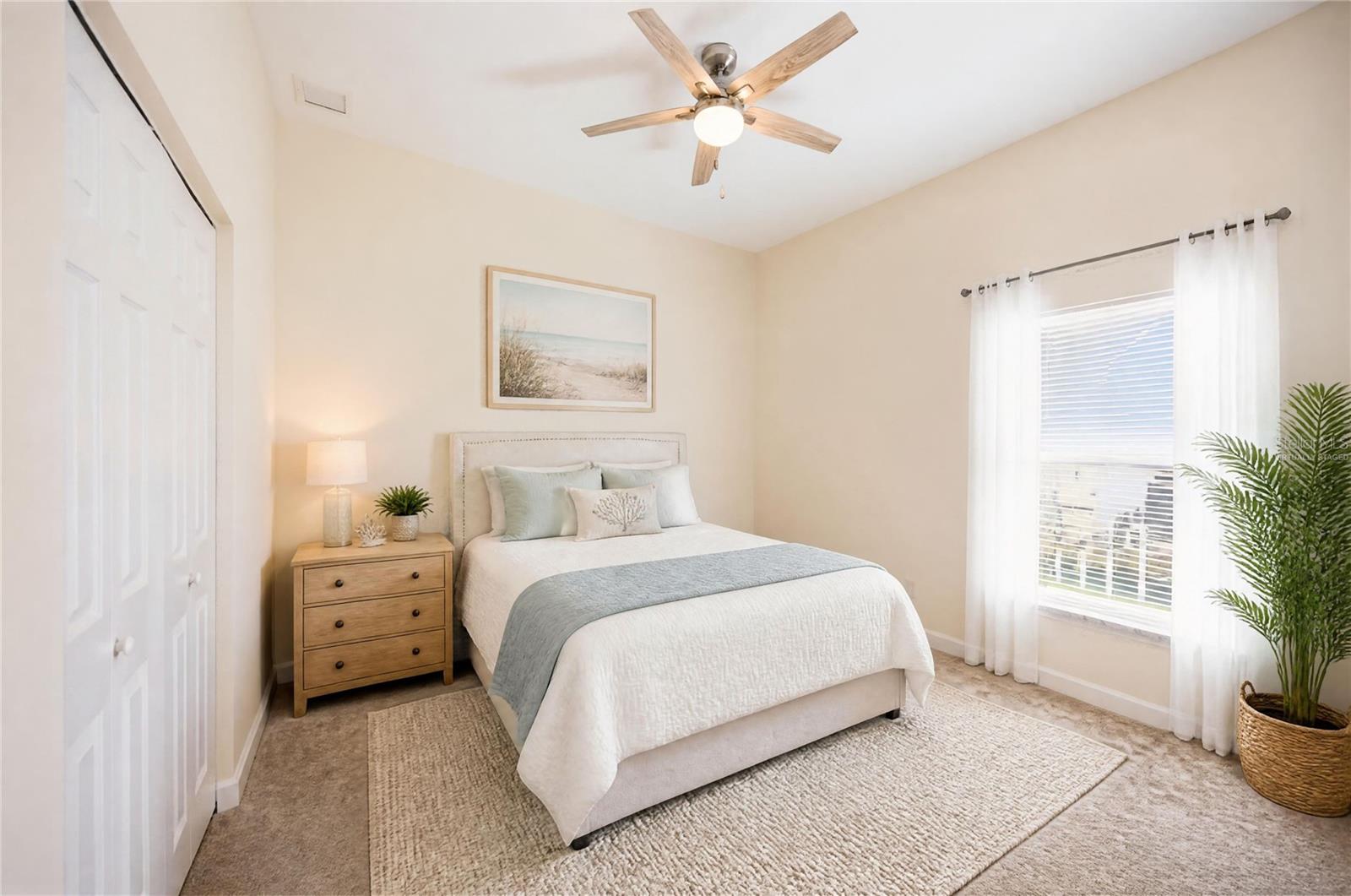 Staged bedroom with a white bed, wooden nightstand, and sunlit window with sheer curtains.
