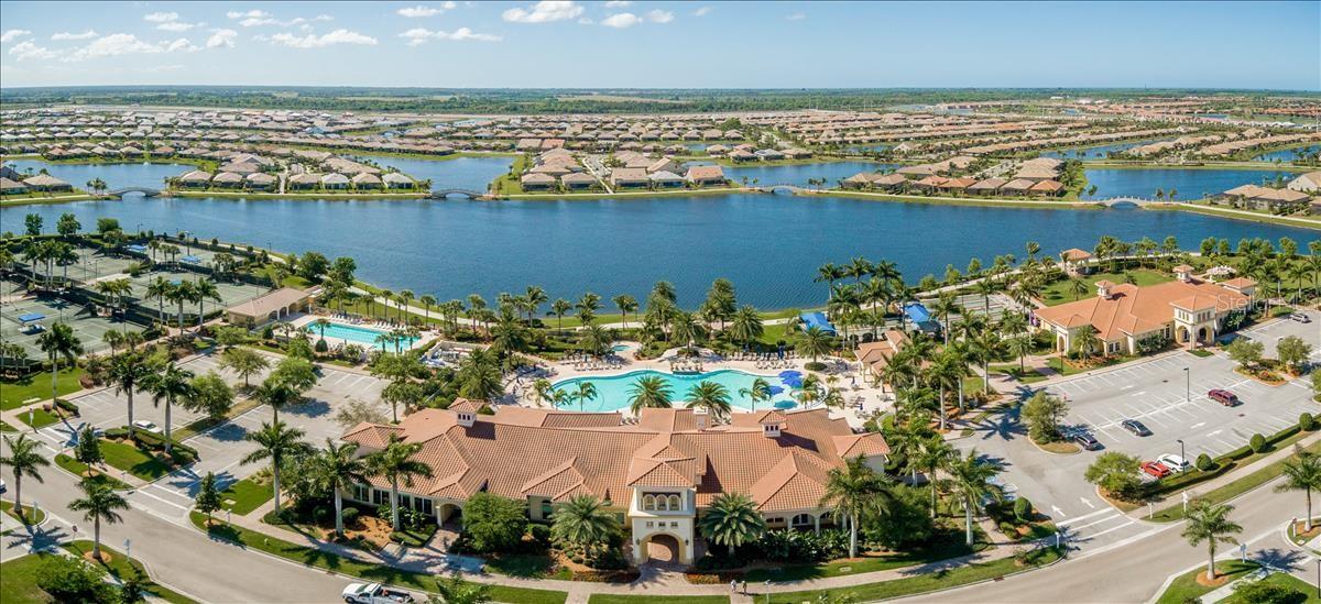 Waterfront community with a lake, clubhouse, swimming pool, and tennis courts.