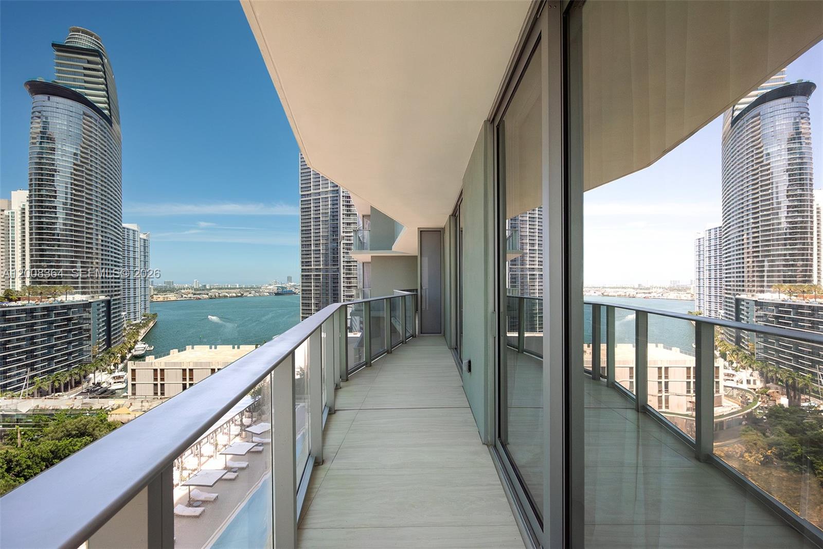 Condo balcony overlooking the water and Miami’s high-rise skyline.