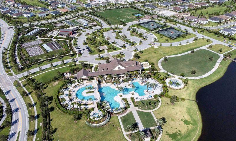 Residential community with a clubhouse, pools, walking paths, and a pond.
