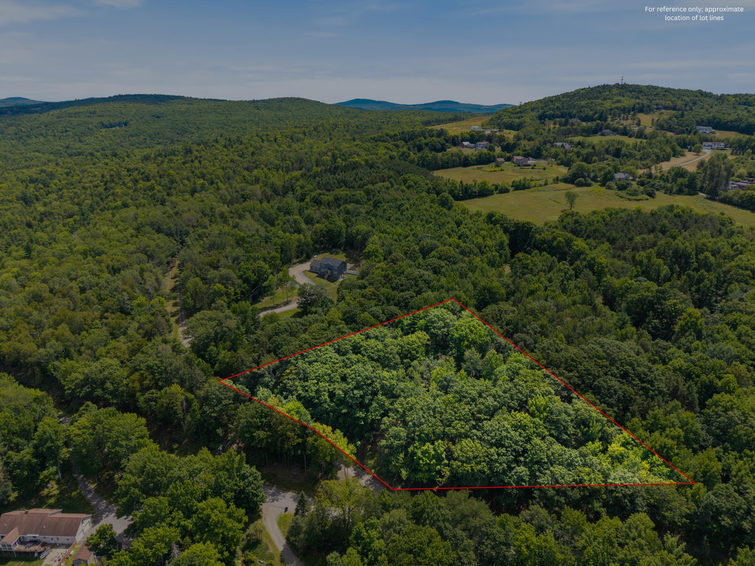 A red outline marks a wooded parcel amid rolling forest and fields.