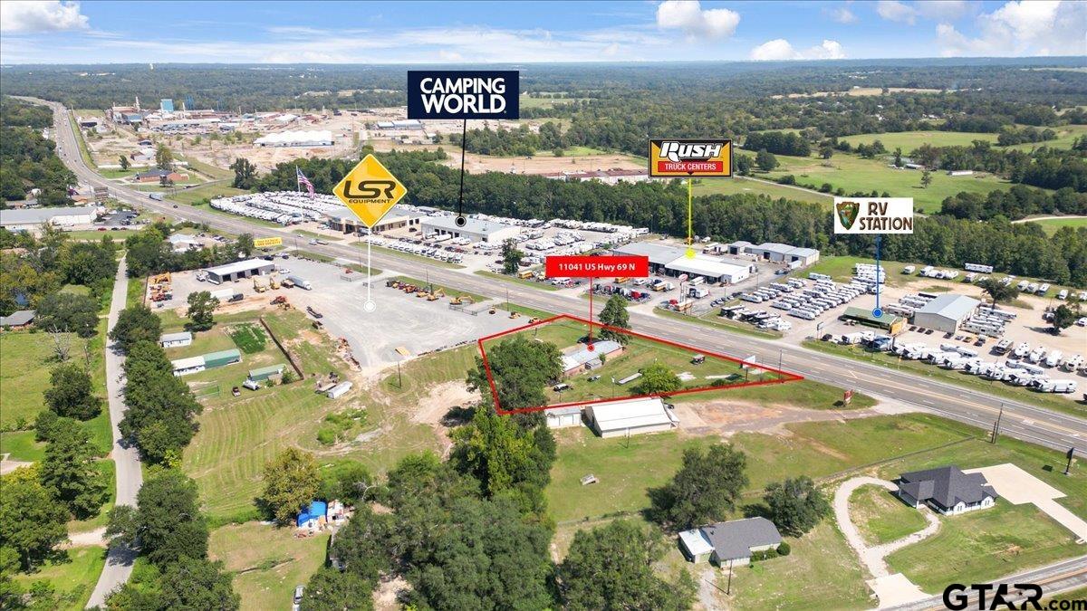 Aerial view of red-outlined highway property beside Camping World and nearby commercial businesses.