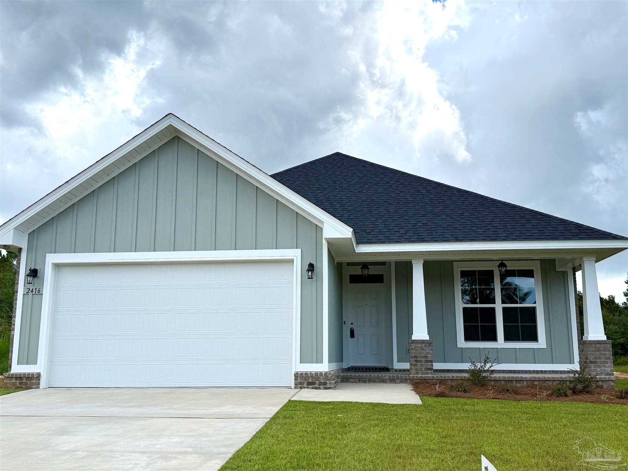 Gray single-story house with white trim, a two-car garage, and a covered front entry.