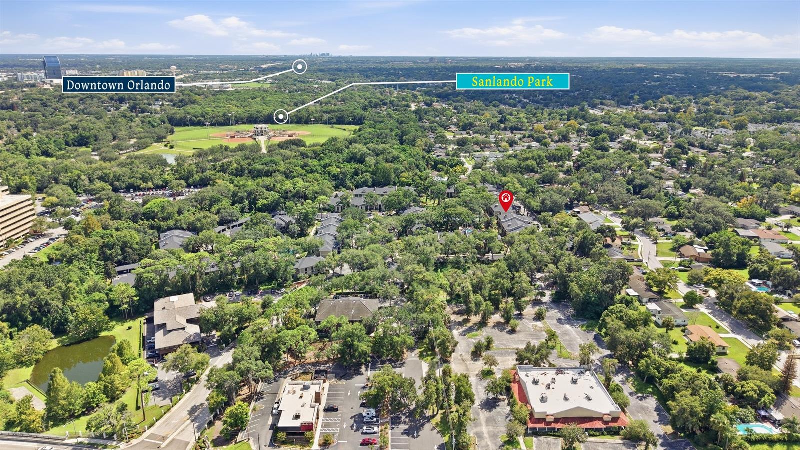 Aerial neighborhood view with the home marked among trees and labels for Downtown Orlando and Sanlando Park.