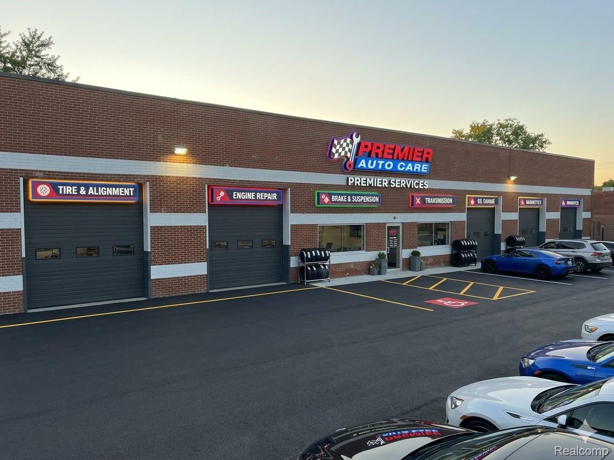 Premier Auto Care service center with multiple garage bays and parked cars.