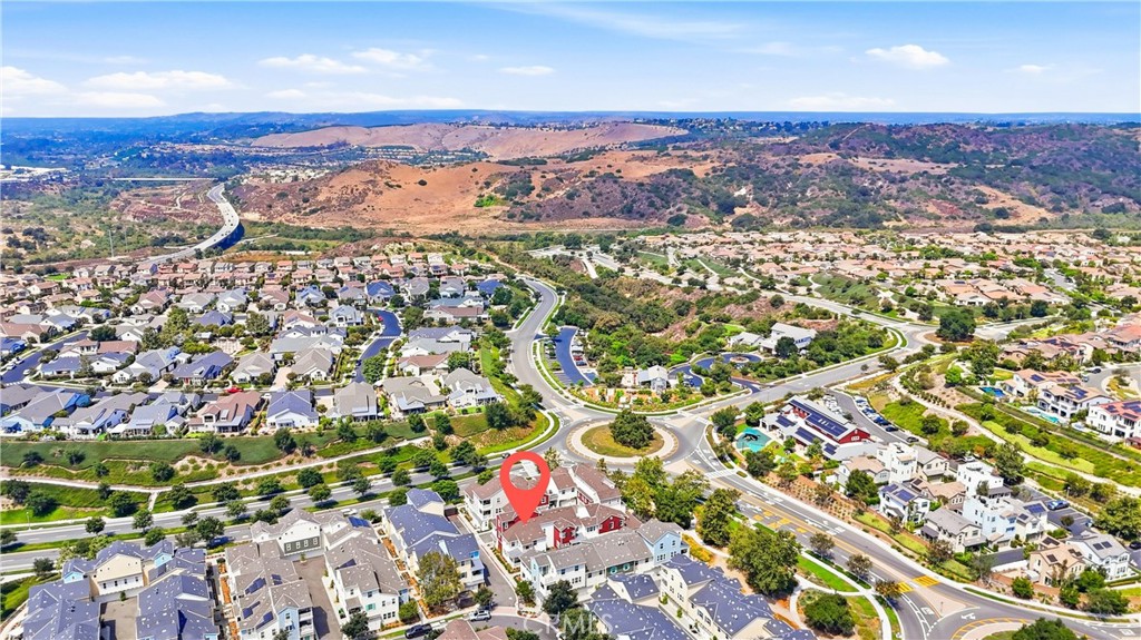 Aerial neighborhood view with a red map pin marking 41 Patria and rolling hills beyond.