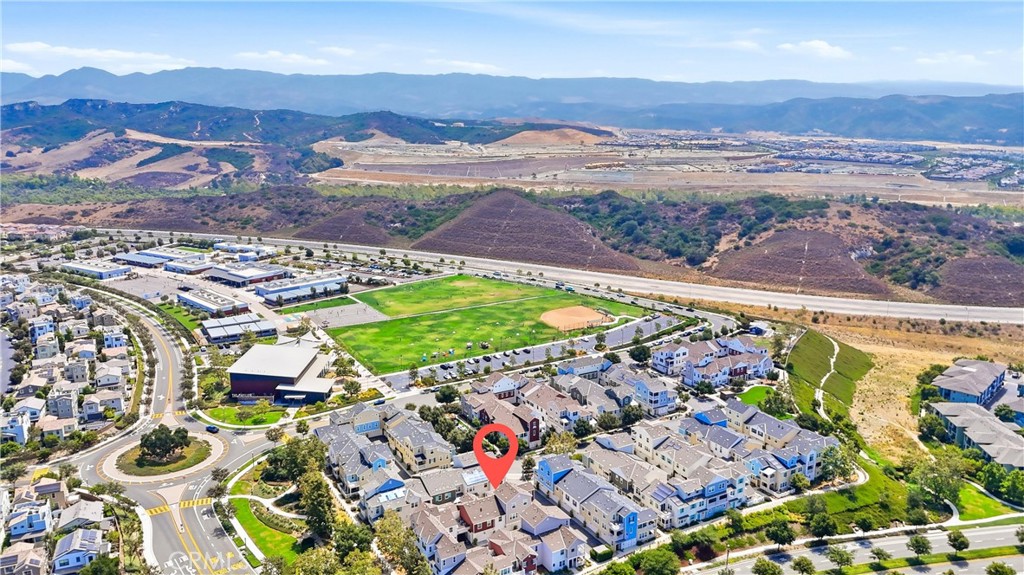 Aerial view of the 41 Patria neighborhood, with sports fields and mountain ranges beyond.