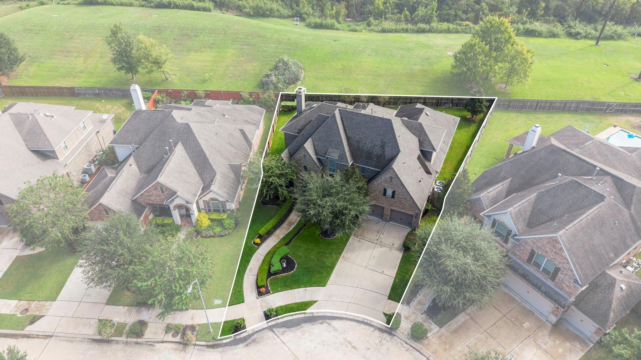 Aerial view of a brick house and yard outlined to show the property boundaries.