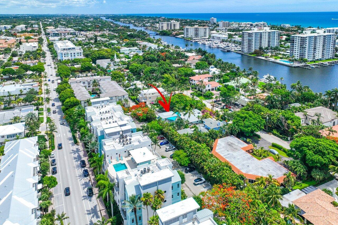 Aerial view of 300 SE 7th Avenue, marked by a red arrow near the waterway and ocean.