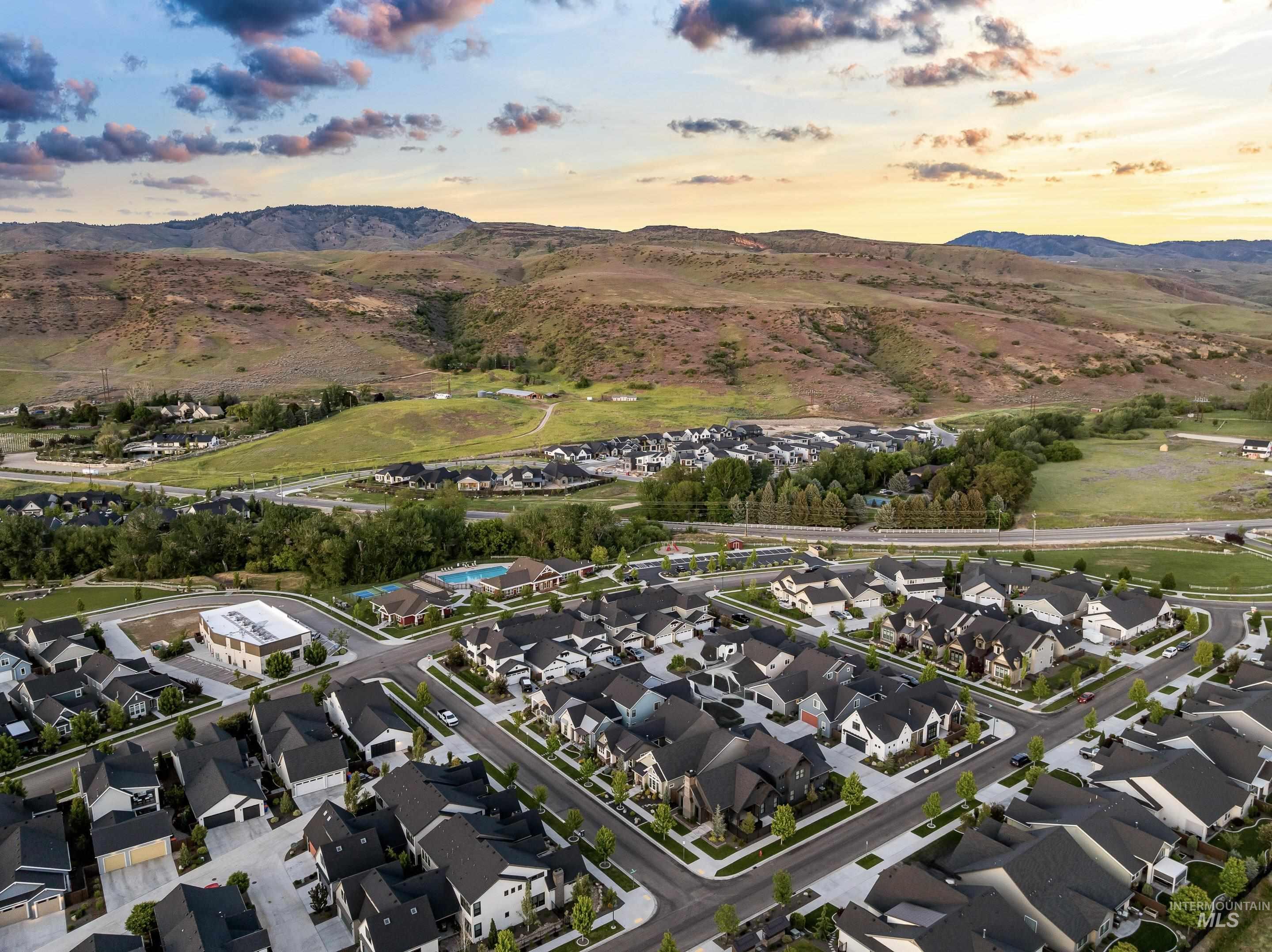 Aerial view of a Boise neighborhood and community pool, with foothills in the background.