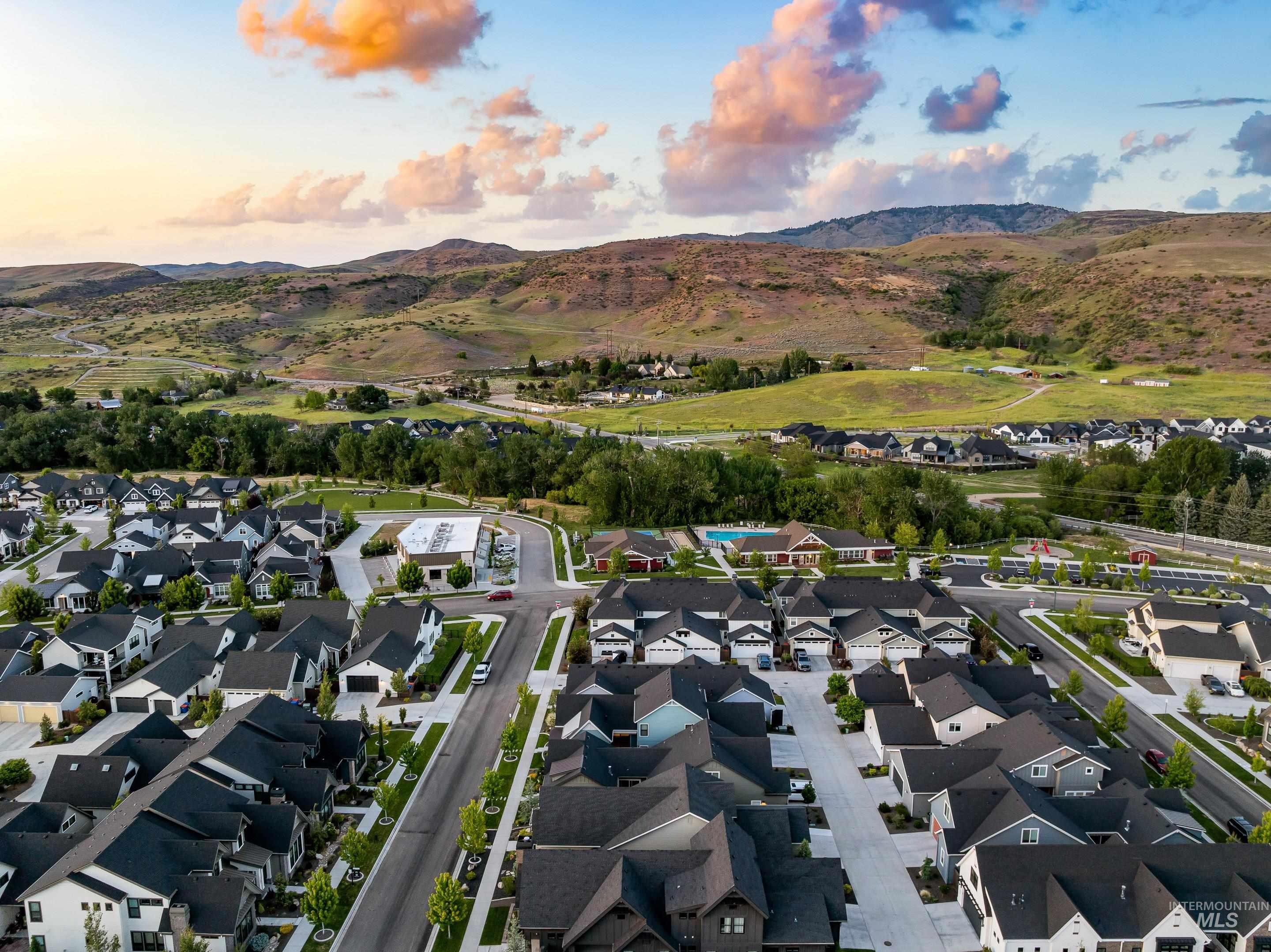 Aerial view of homes in Cartwright Ranch, with a community pool and rolling foothills beyond.