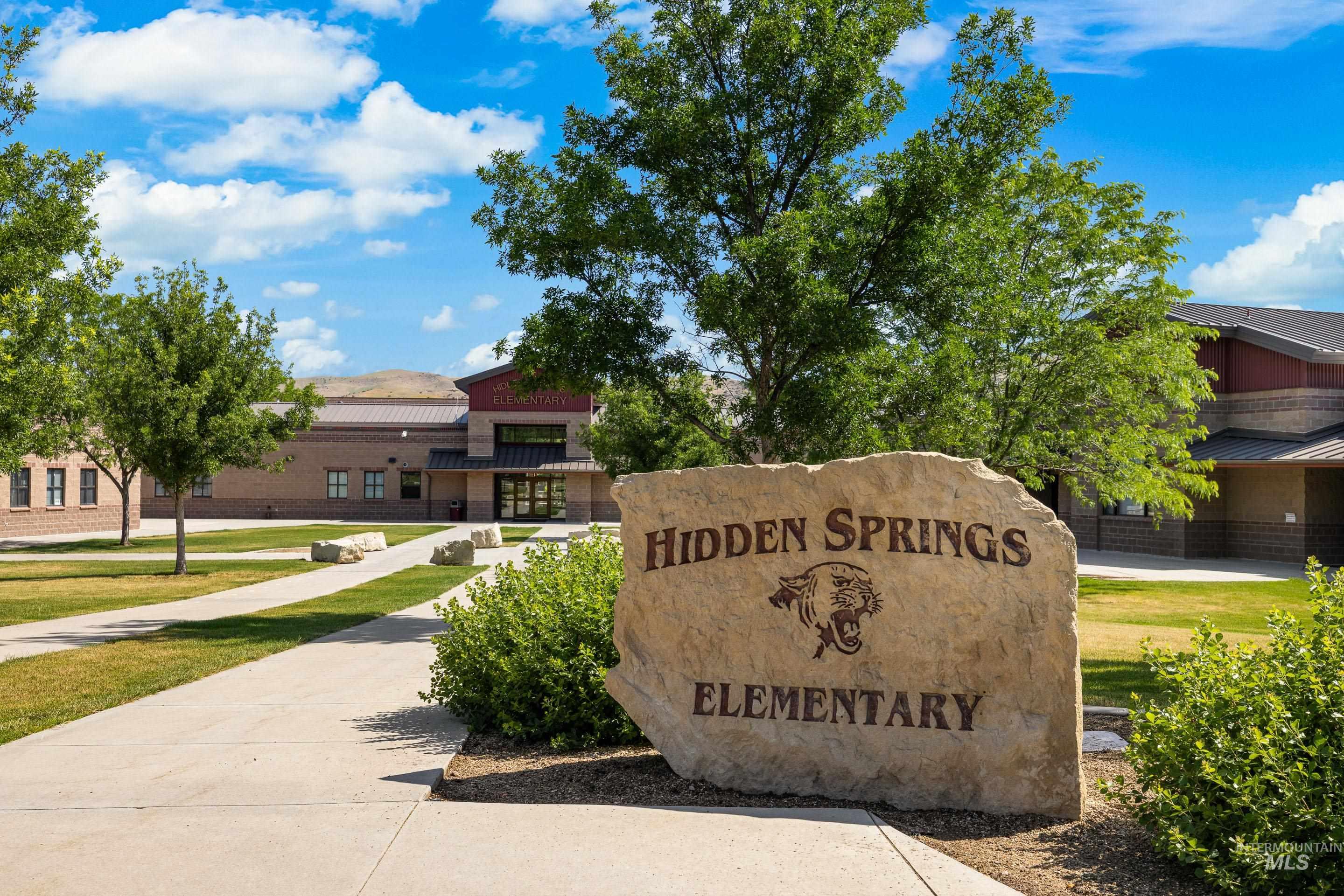Hidden Springs Elementary entrance behind a large stone school sign.