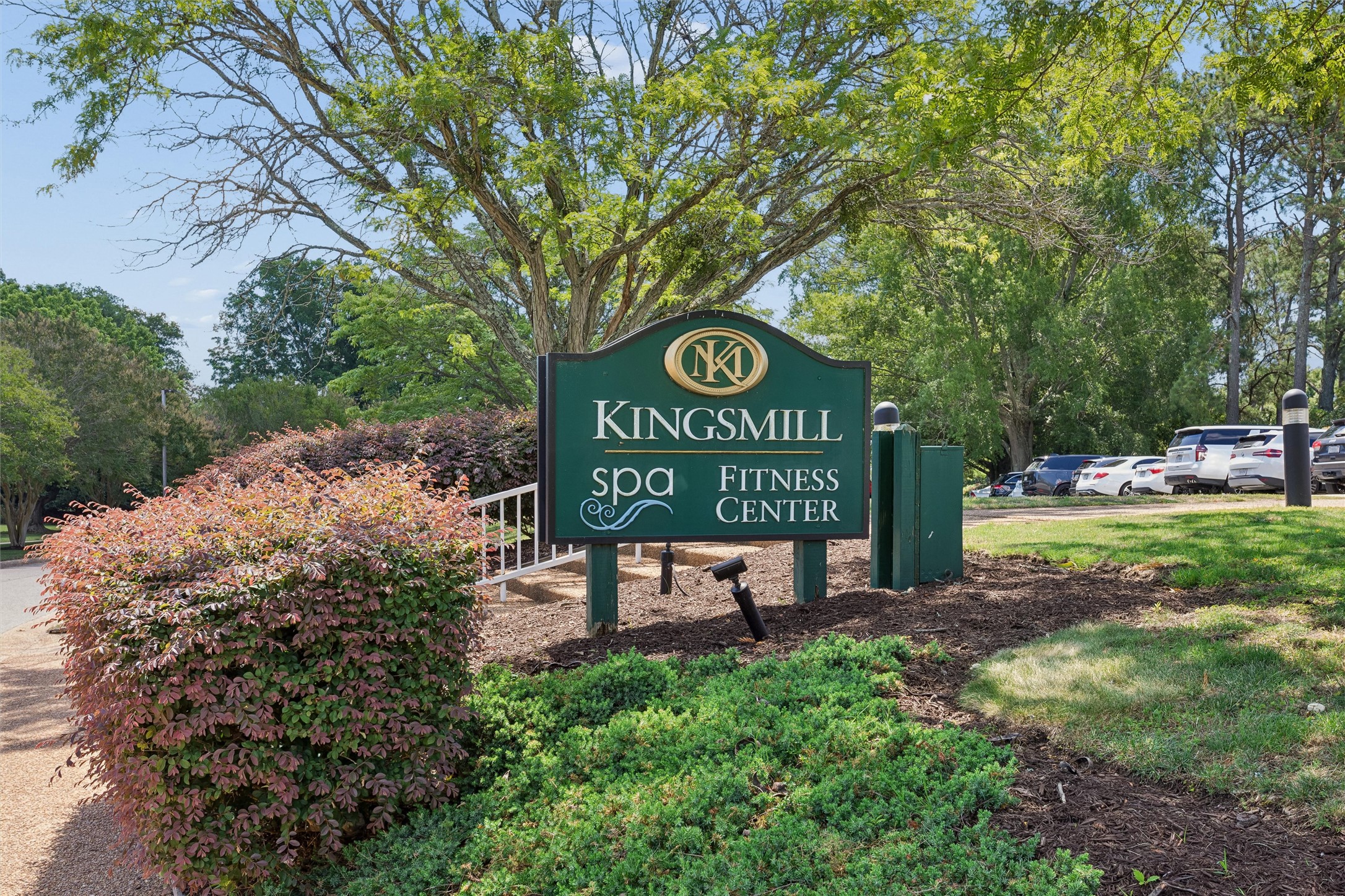 Kingsmill Spa and Fitness Center sign beside landscaped grounds and parking.
