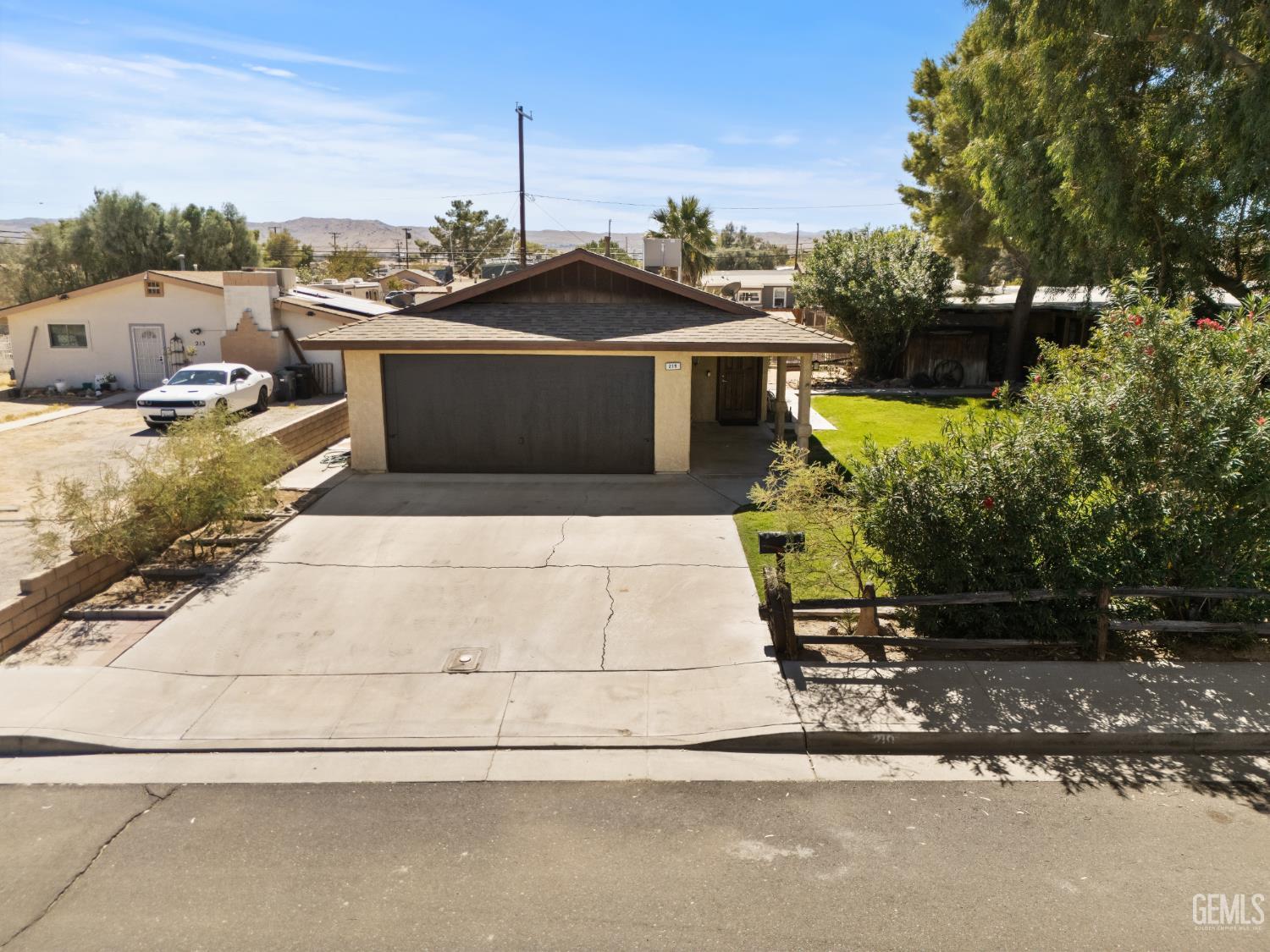 Single-story home with a wide driveway, two-car garage, and covered front entry.